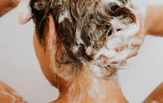 Washing hair with medicated shampoo to help relieve itchy, flaky scalp caused by psoriasis or seborrhoeic dermatitis