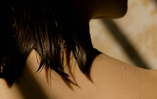 Close up of wet hair and skin with moody lighting